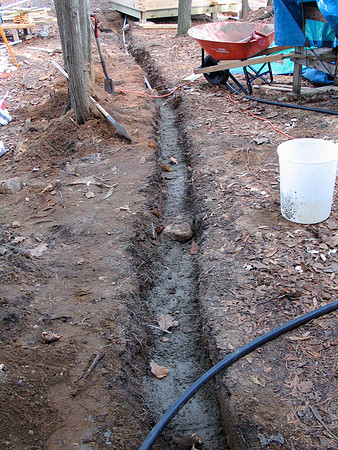 Shallow trench because of bedrock, we covered the conduit with concrete.