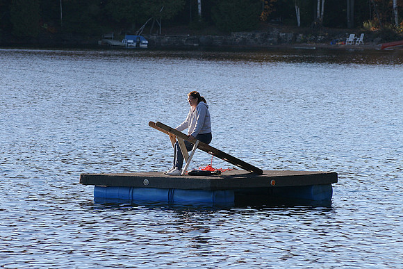 Putting away the swim dock, with Judy waiting for a tow.